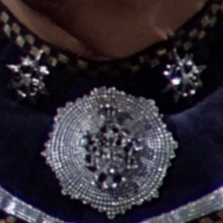Another possible appearance of the Seal as seen on Adama's blue commander's uniform.
