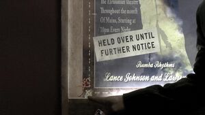 Caprica - Ghosts in the Machine - Tamara's Mark Above a Mysteries Poster.jpg