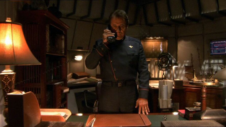 Adama's desk with model ship in the background.