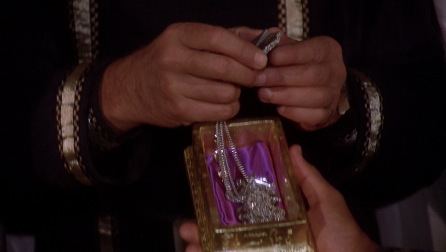 As Seal Bearer, Tigh presents Adama the Seal of the Lords.