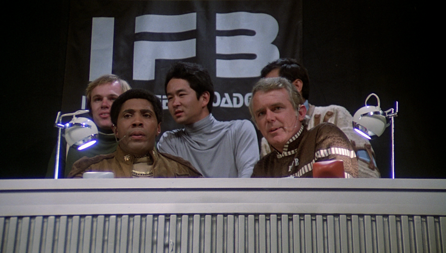 Boomer and Zed provide sports coverage from a booth used by Inter-Fleet Broadcasting (TOS: "Murder on the Rising Star").