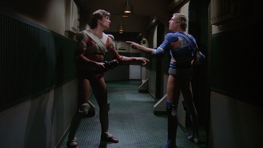 Corridor outside a locker room where rivals Starbuck and Ortega spar after a heated Triad game (TOS: "Murder on the Rising Star").