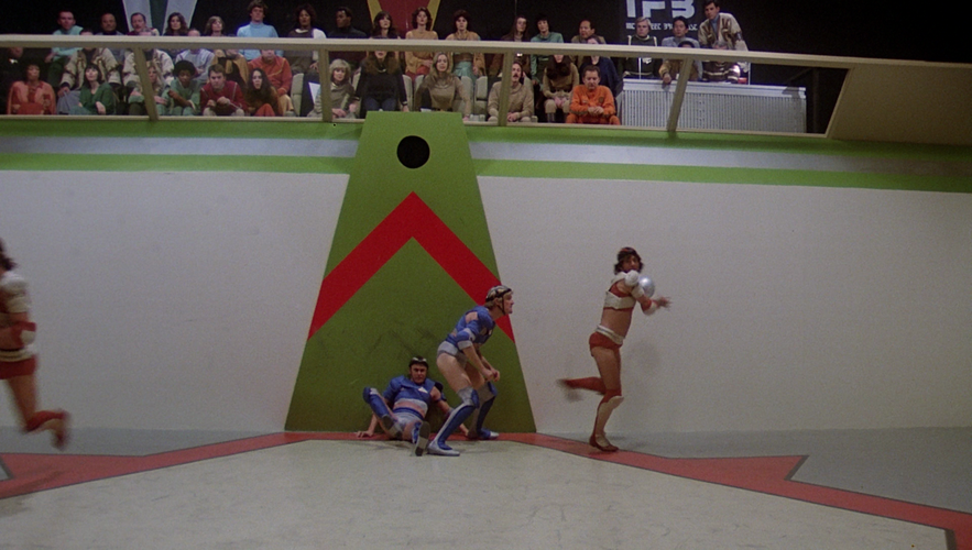 The Triad court with spectators looking downward, and protected by a clear glass-like barrier (TOS: "Murder on the Rising Star").