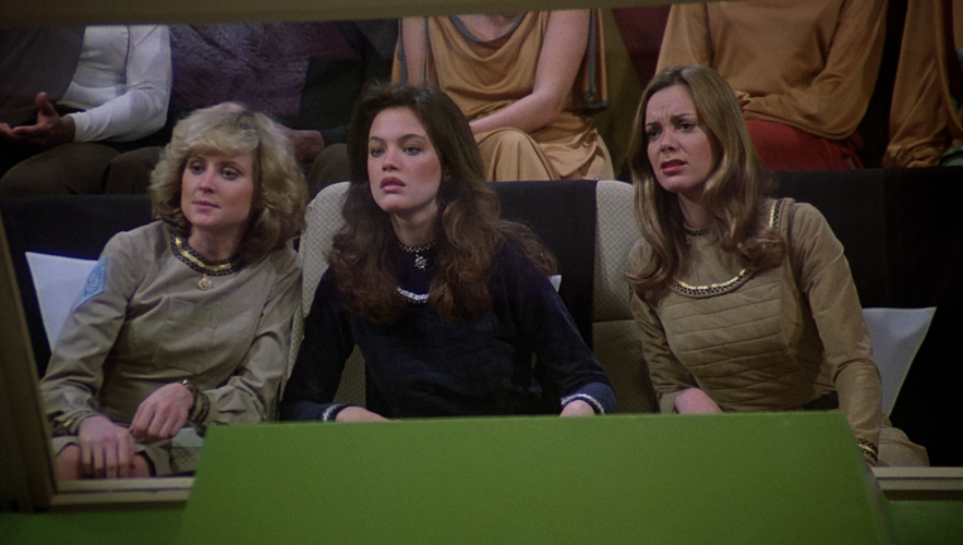 VIP (Very Important Person) seating situated above the green goal at the Triad court. Seated are Cassiopeia, Athena and Sheba (TOS: "Murder on the Rising Star").
