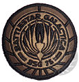 Smaller Galactica patch worn on the gray sweatpant.