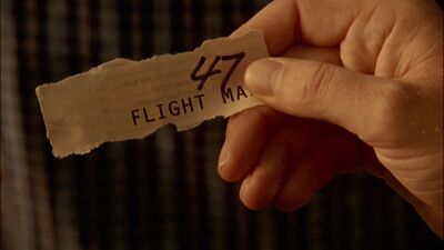 The older woman next to Gaius Baltar holds a winning ticket for a seat on Raptor 312 (TRS: "Miniseries, Night 1").