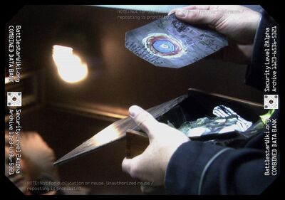 Karl "Helo" Agathon pulls out Kara "Starbuck" Thrace's Foliole box with a picture of the mandala painting from her Caprica apartment (TRS: "Rapture").