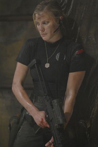 Kara Thrace with a stripped down version of attack gear. Note the shirt with the emblem over the left breast (TRS: "Razor").
