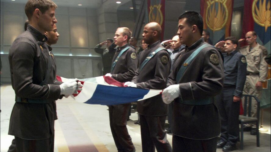 An honor guard at a military funeral (TRS: "Act of Contrition").